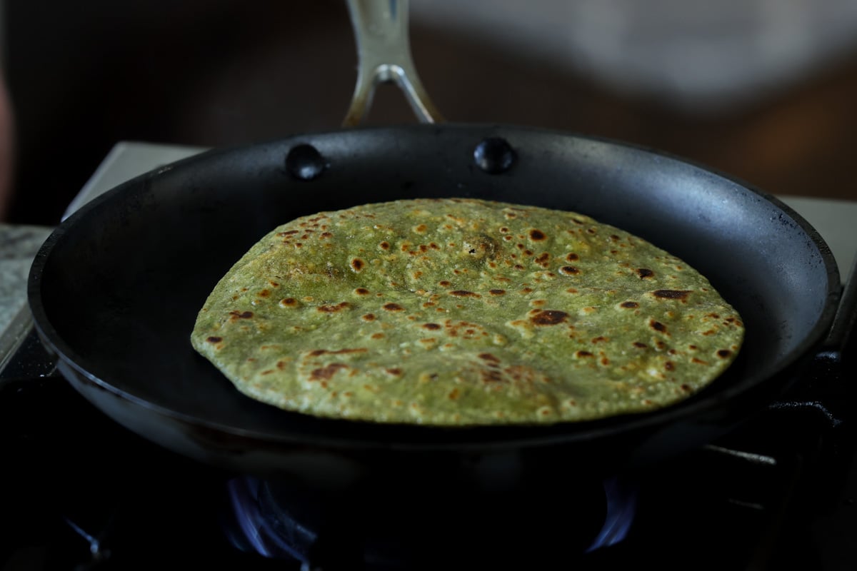 spinach paratha in the pan after cooking