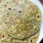 serving plate of spinach parathas