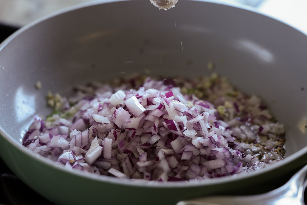 adding onion to the pan