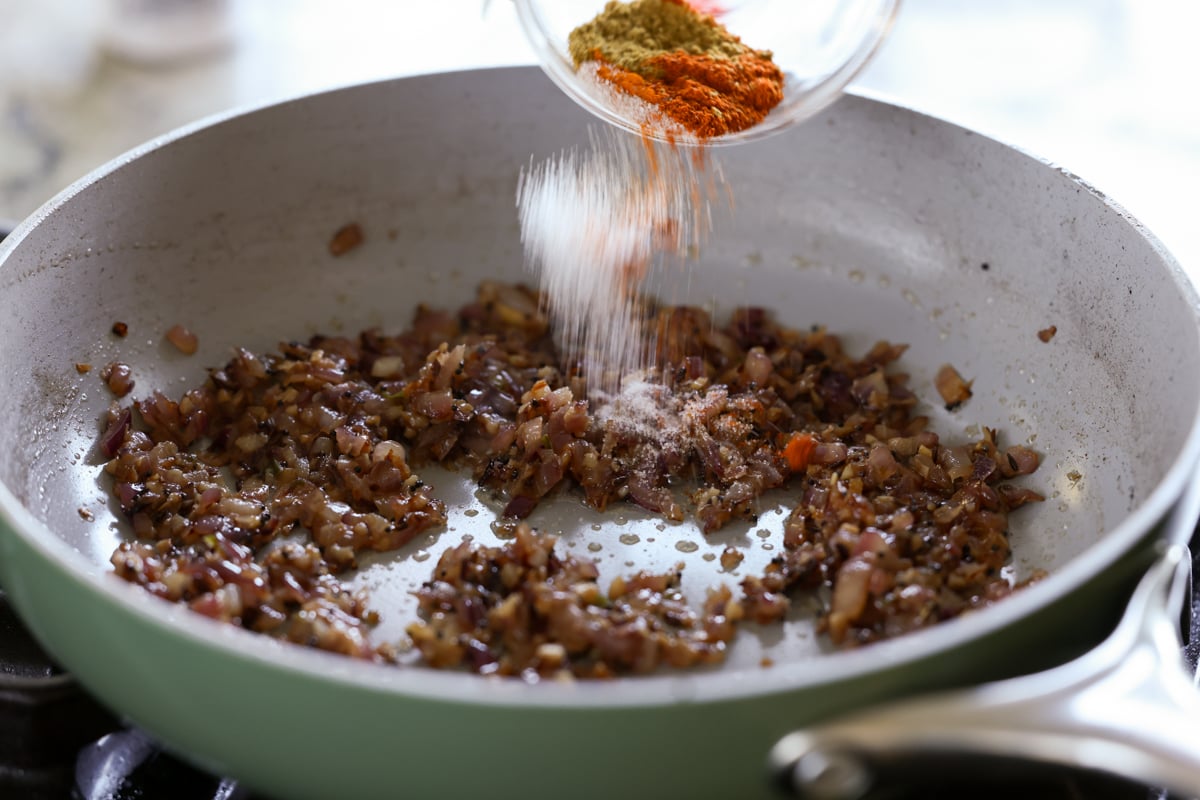 adding ground spices to the cooked aromatics