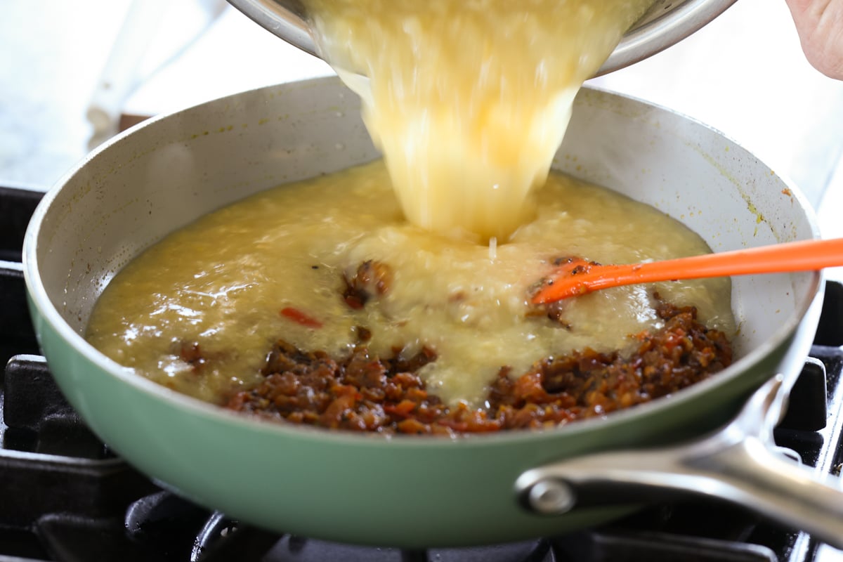adding dal to the tempering in the pan