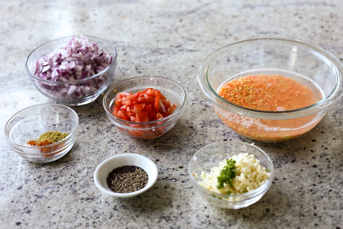 dal fry ingredients in bowls on a kitchen counter