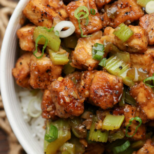 close-up of a bowl of celery black pepper tofu with rice