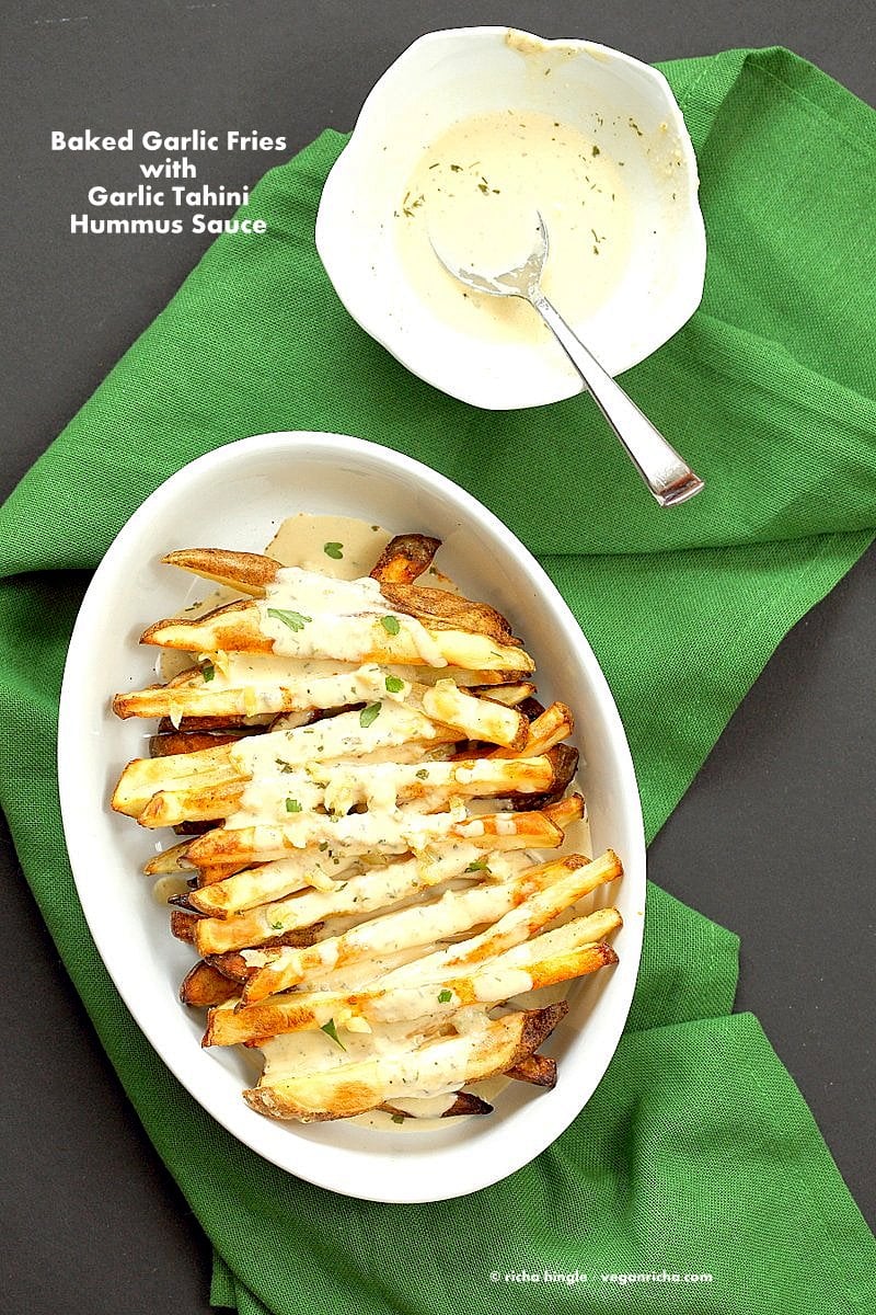 Baked Fries with Garlic Sauce - Russet potato baked and drenched in tahini hummus lemon sauce | VeganRicha.com #vegan #appetizer #glutenfree #soyfree #recipe