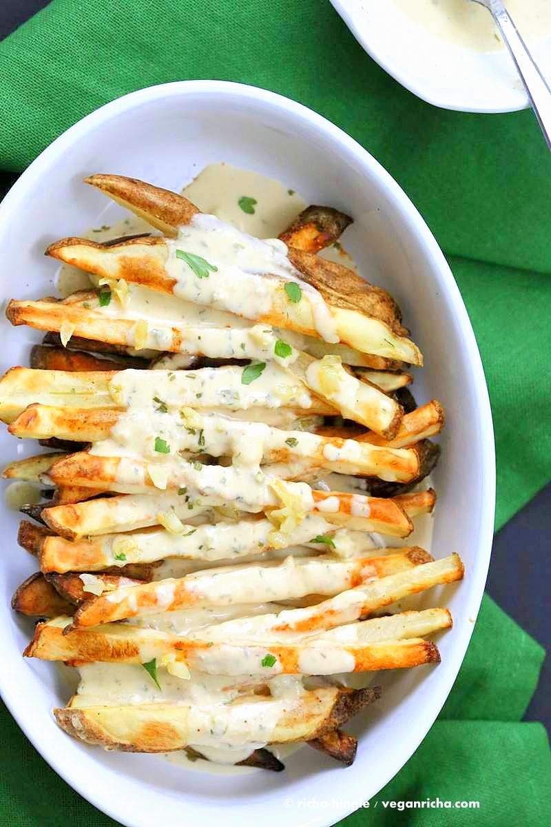 Baked Fries with Garlic Sauce - Russet potato baked and drenched in garlic tahini hummus lemon sauce | VeganRicha.com #vegan #appetizer #glutenfree #soyfree #recipe
