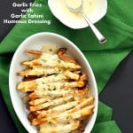 Baked Fries with Garlic Sauce - Russet potato baked and drenched in tahini hummus lemon sauce | VeganRicha.com #vegan #appetizer #glutenfree #soyfree #recipe #veganricha