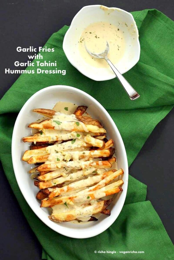 Baked Fries with Garlic Sauce - Russet potato baked and drenched in tahini hummus lemon sauce | VeganRicha.com #vegan #appetizer #glutenfree #soyfree #recipe #veganricha