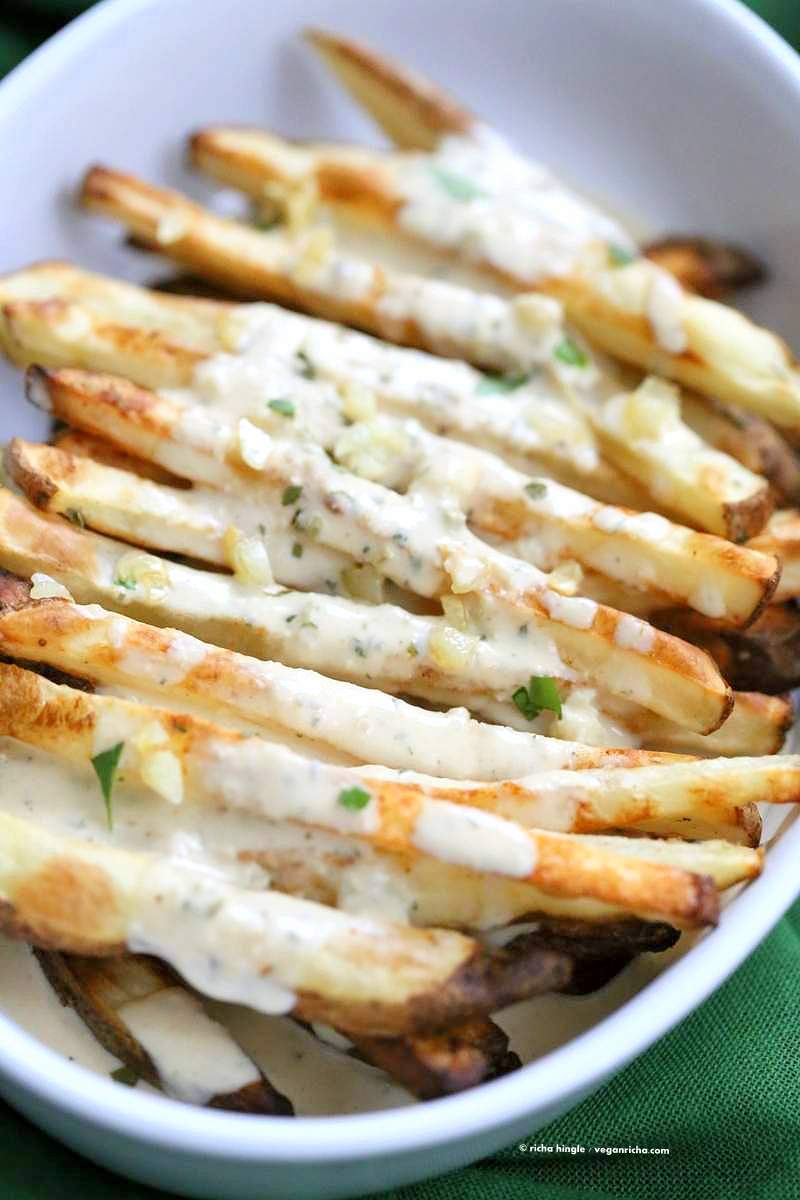 Baked Fries with Garlic Sauce - Russet potato baked and drenched in garlic tahini hummus lemon sauce | VeganRicha.com #vegan #appetizer #glutenfree #soyfree #recipe