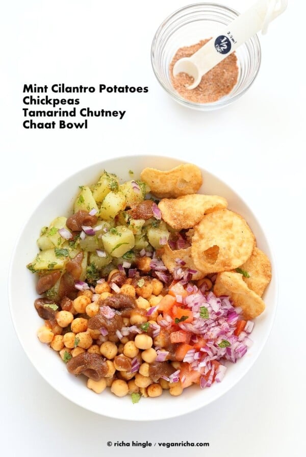Chickpea Aloo Chaat Bowl. Mint cilantro Potatoes, spiced chickpeas, tamarind date chutney bowl with onions, tomatoes and chaat masala. | VeganRicha.com #vegan #glutenfree #bowl #recipe #glutenfree #veganricha #vegan