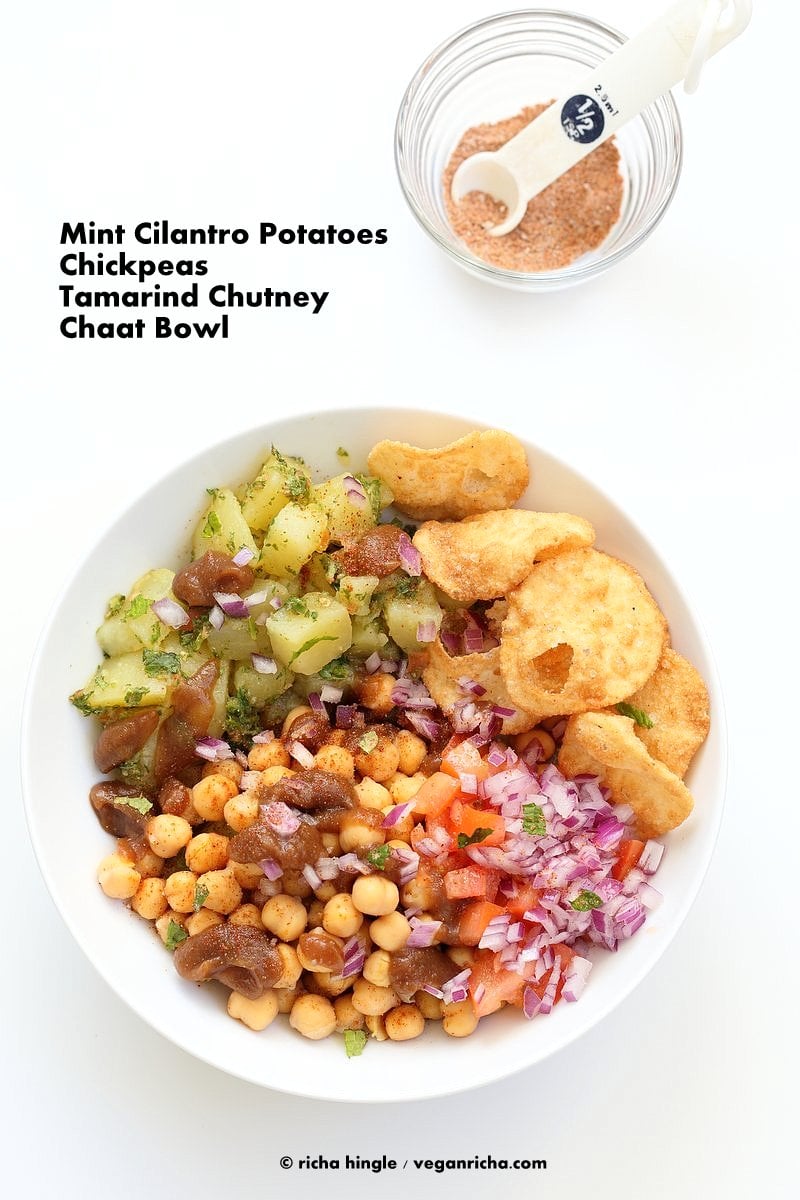 Chickpea Aloo Chaat Bowl. Mint cilantro Potatoes, spiced chickpeas, tamarind date chutney bowl with onions, tomatoes and chaat masala. | VeganRicha.com #vegan #glutenfree #bowl #recipe