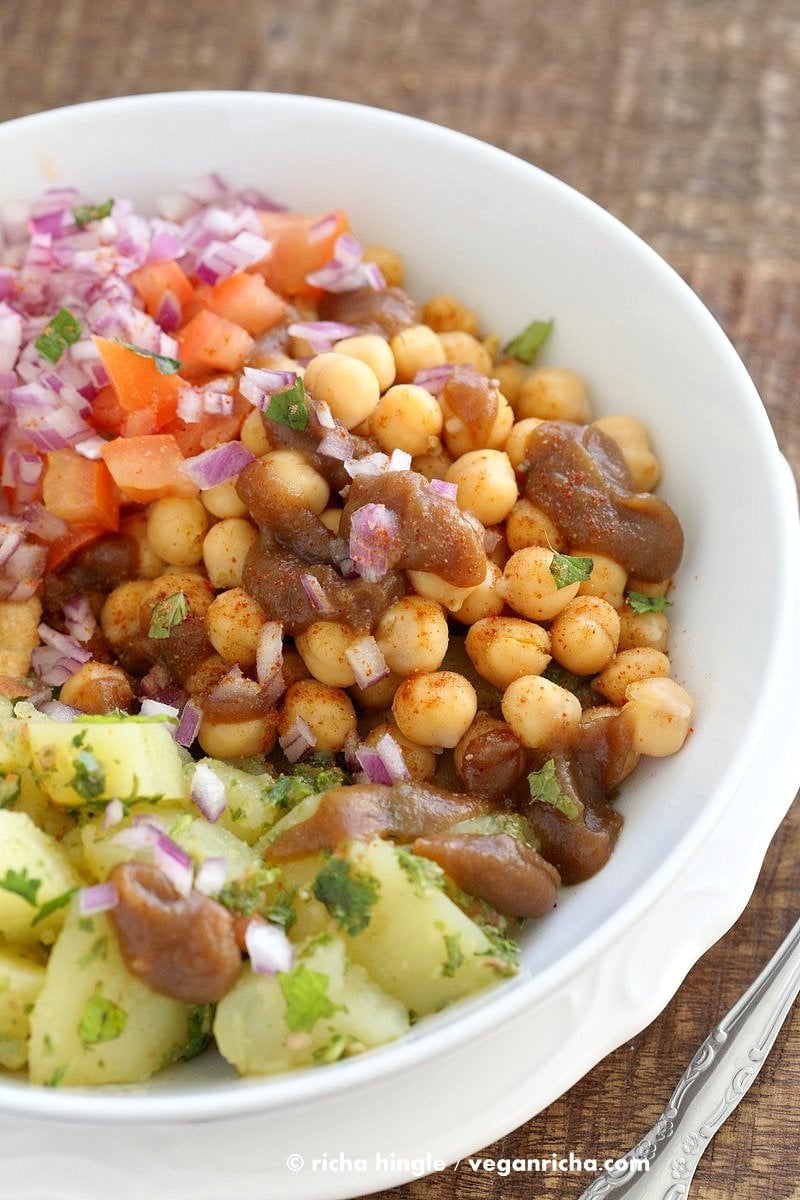 Chickpea Aloo Chaat Bowl. Mint cilantro Potatoes, spiced chickpeas, tamarind date chutney bowl with onions, tomatoes and chaat masala. | VeganRicha.com #vegan #glutenfree #bowl #recipe