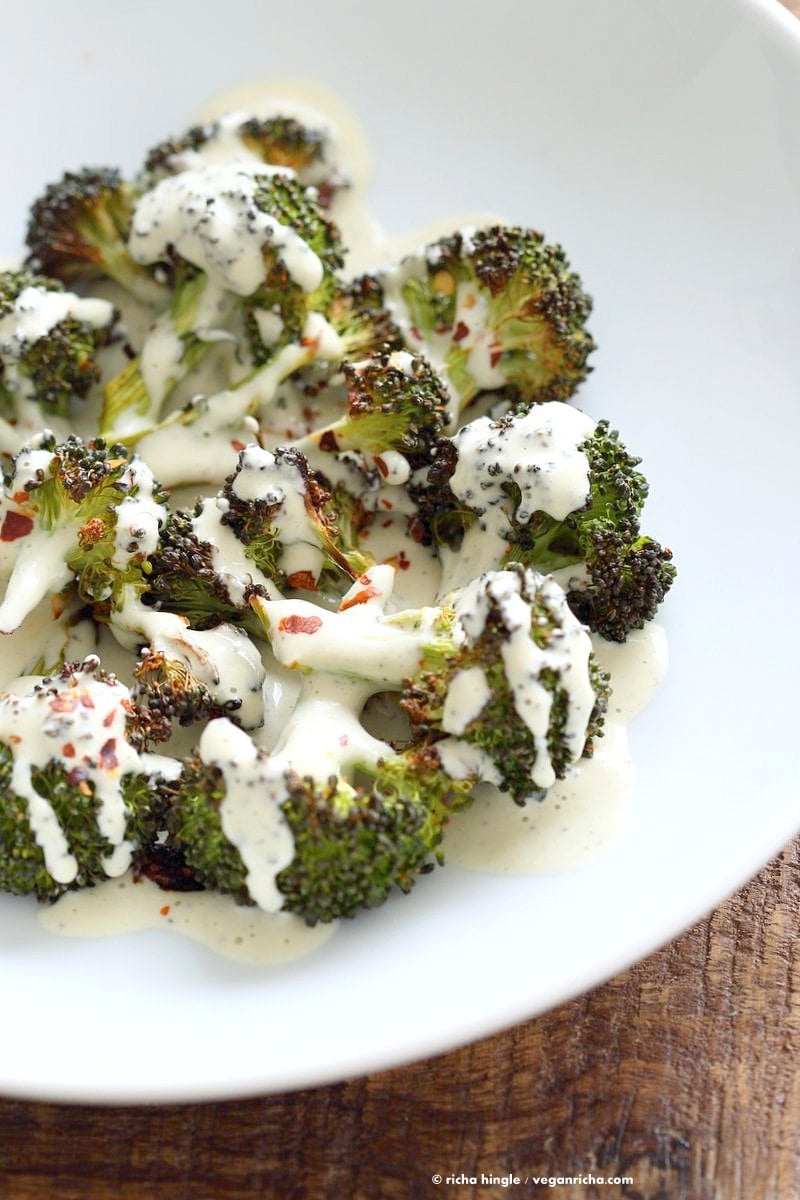 Roasted Broccoli with Creamy Basil Dressing. Broccoli tossed in garlic, cayenne, and baked. Served with cheesy cashew basil sauce. Vegan Gluten-free soy-free Recipe | VeganRicha.com #vegan #glutenfree #soyfree