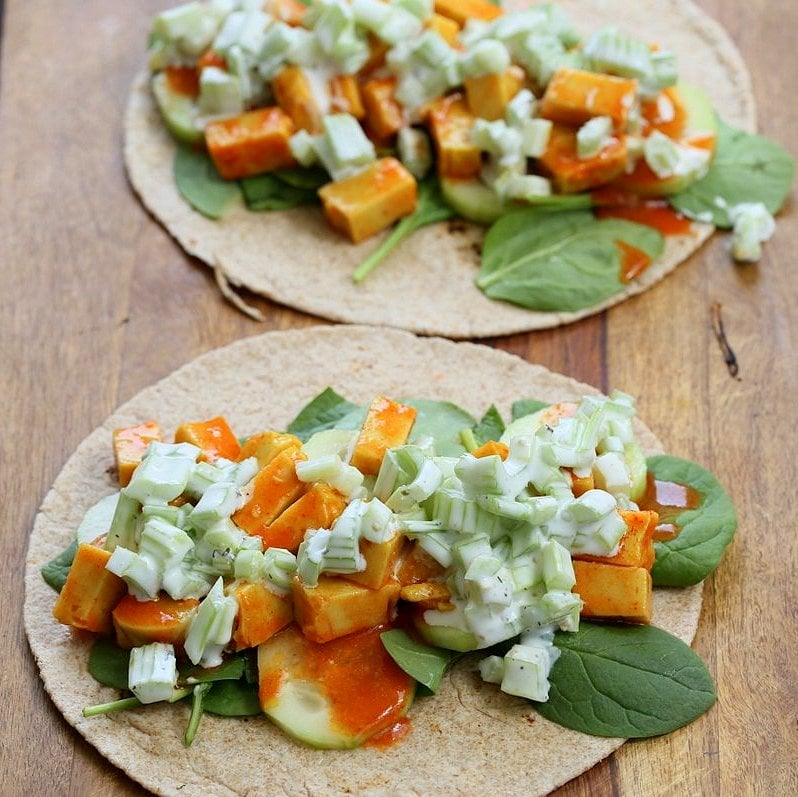 Buffalo Tofu wrap with Chickpea Tofu. Soy-free Chickpea flour Tofu tossed in buffalo hot sauce, layered with celery, spinach, cucumbers and vegan ranch. Easy weekday meal Recipe | VeganRicha.com