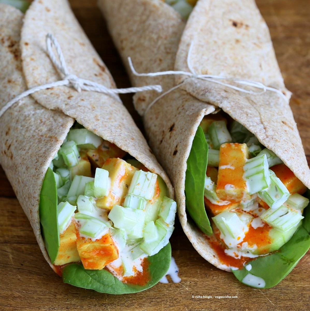 Buffalo Tofu wrap with Chickpea Tofu. Soy-free Chickpea flour Tofu tossed in buffalo hot sauce, layered with celery, spinach, cucumbers and vegan ranch. Easy weekday meal Recipe | VeganRicha.com