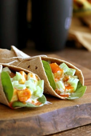 Buffalo Tofu wrap with Chickpea Tofu. Soy-free Chickpea flour Tofu tossed in buffalo hot sauce, layered with celery, spinach, cucumbers and vegan ranch. Easy weekday meal Recipe | VeganRicha.com