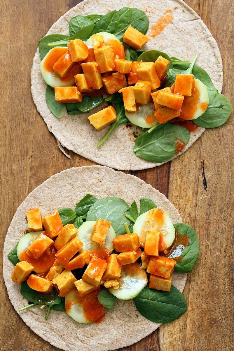 Buffalo Tofu wrap with Chickpea Tofu. Soy-free Chickpea flour Tofu tossed in buffalo hot sauce, layered with celery, spinach, cucumbers and vegan ranch. Easy weekday meal Recipe | VeganRicha.com