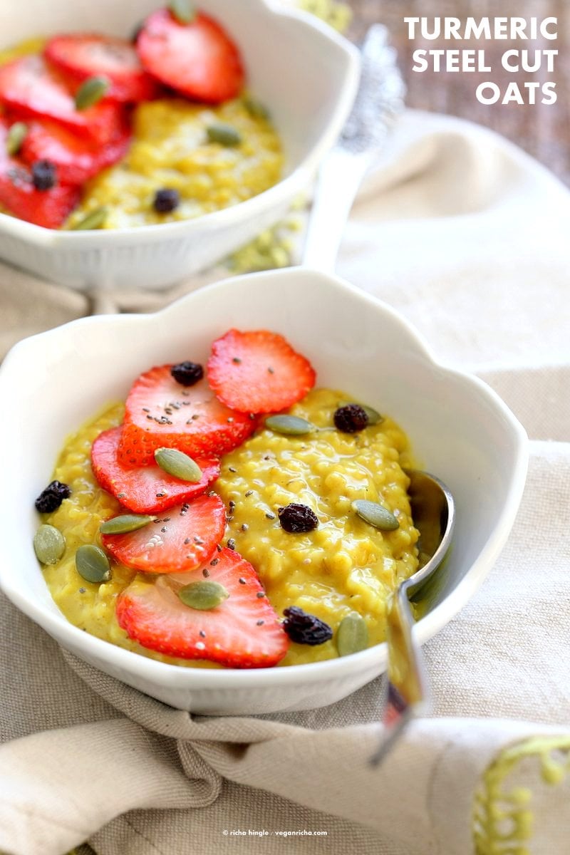 Turmeric Steel Cut Oats. Golden Milk Oats with turmeric, cinnamon and cardamom. Serve with Strawberries, chia seeds and other garnishes of choice. Easy Make ahead Breakfast Recipe Vegan Glutenfree Soyfree.| VeganRicha.com