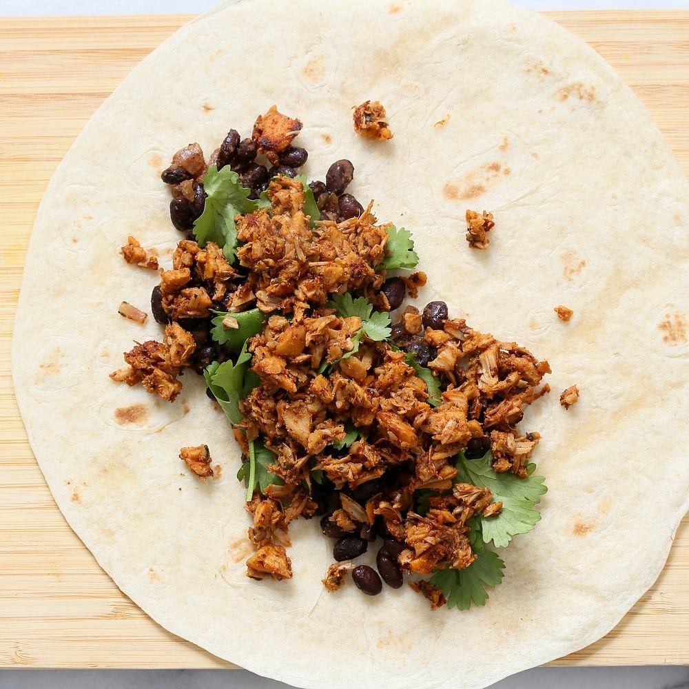 Jamaican Jerk Jackfruit Caribbean Black Bean Mango Wraps. These Burritos are packed with hot shredded jerk jackfruit, black beans, mango and cucumbers. Serve as wraps or make a sandwich or bowl. Vegan Soy-free Recipe. Can be gluten-free | VeganRicha.com