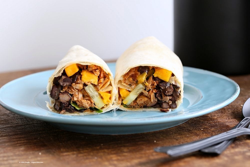 Jamaican Jerk Jackfruit Caribbean Black Bean Mango Wraps. These Burritos are packed with hot shredded jerk jackfruit, black beans, mango and cucumbers. Serve as wraps or make a sandwich or bowl. Vegan Soy-free Recipe. Can be gluten-free | VeganRicha.com