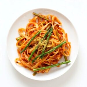 Fettuccine with Tomato Cream Sauce and Asparagus. Easy tomato Cream sauce with pasta and garlic roasted Asparagus. Use other veggies of choice. Add some chickpea chorizo or smoked coconut for variation. Vegan Soyfree Recipe. Can be gluten-free with gf pasta. | VeganRicha.com #vegan #glutenfree #veganricha