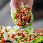 hand holding gochujang chickpeas lettuce wraps