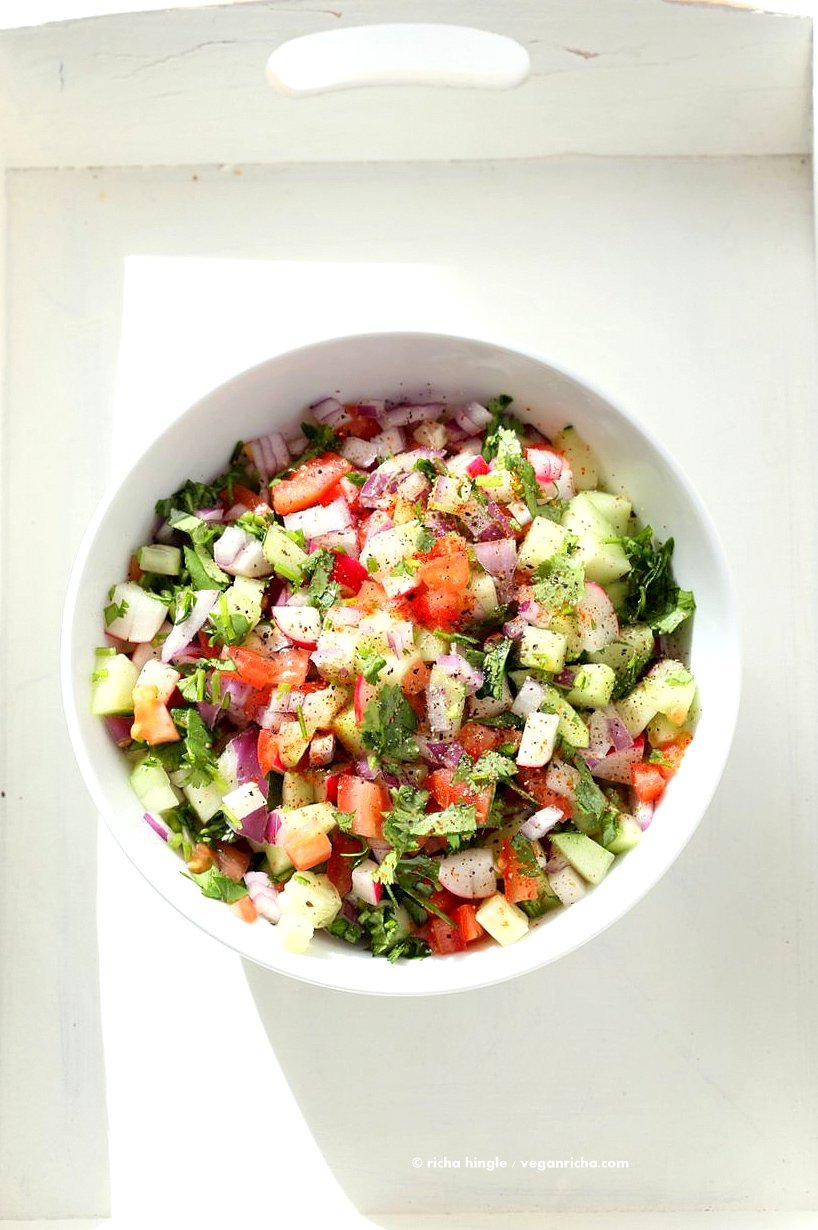 Kachumber Salad - Cucumber Tomato Onion Salad Recipe. Kachumbar is a simple chopped Summer Salad with chopped onions, tomatoes, cucumbers and a salt pepper lemon dressing. Serve as a side with Indian curries, or as a dip with chips, or over burgers. Vegan Gluten-free Soy-free Oil-free Recipe | VeganRicha.com