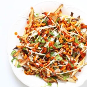 Baked Vietnamese fries. Baked Potato strips, loads of cilantro and basil, bean sprouts, nuts in sweet chile sauce, sriracha and vegan mayo! Banh mi Sandwich in fries form. Vegan Gluten-free Recipe. | VeganRicha.com #vegan #glutenfree #veganricha