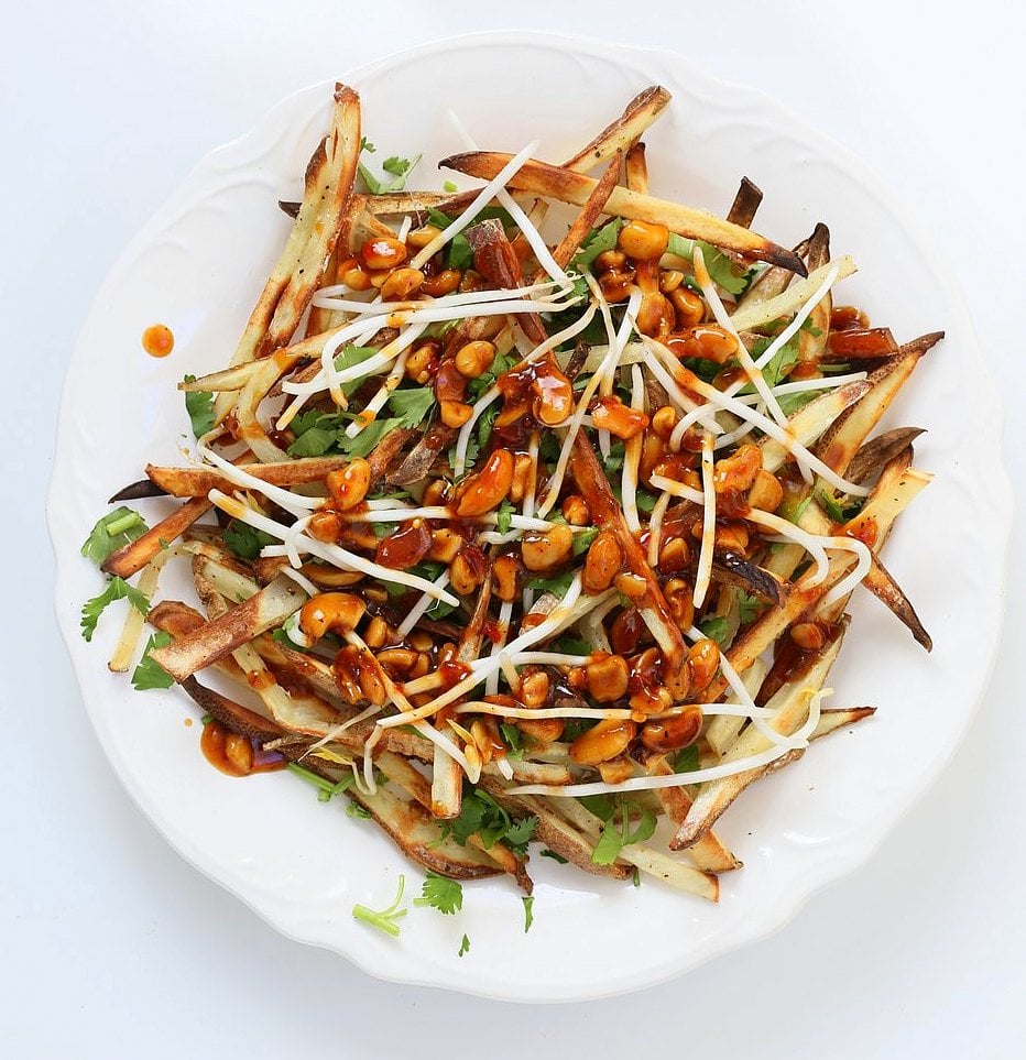 Baked Vietnamese fries. Baked Potato strips, loads of cilantro and basil, bean sprouts, nuts in sweet chile sauce, sriracha and vegan mayo! Banh mi Sandwich in fries form. Vegan Gluten-free Recipe. | VeganRicha.com