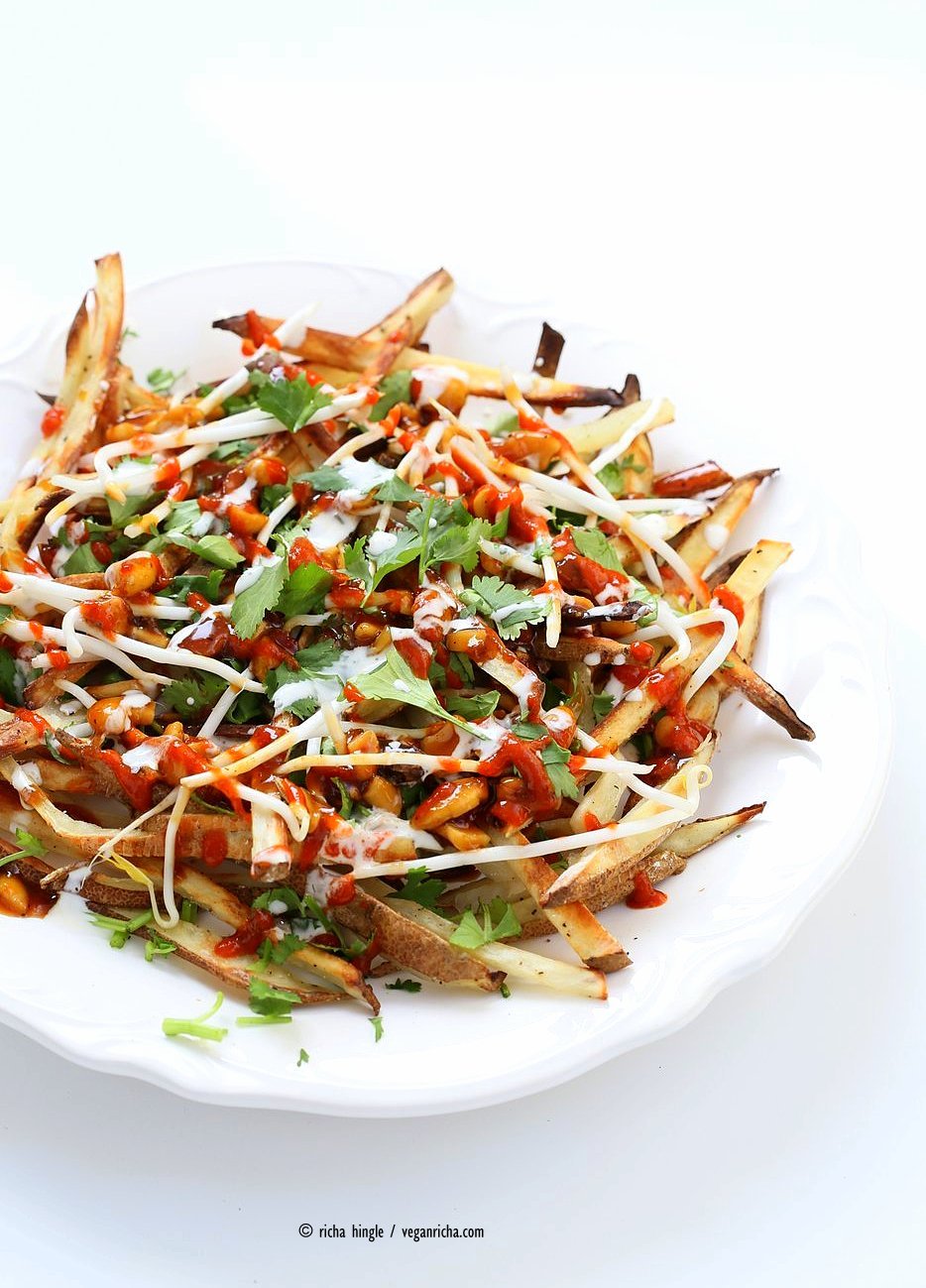 Baked Vietnamese fries. Baked Potato strips, loads of cilantro and basil, bean sprouts, nuts in sweet chile sauce, sriracha and vegan mayo! Banh mi Sandwich in fries form. Vegan Gluten-free Recipe. | VeganRicha.com