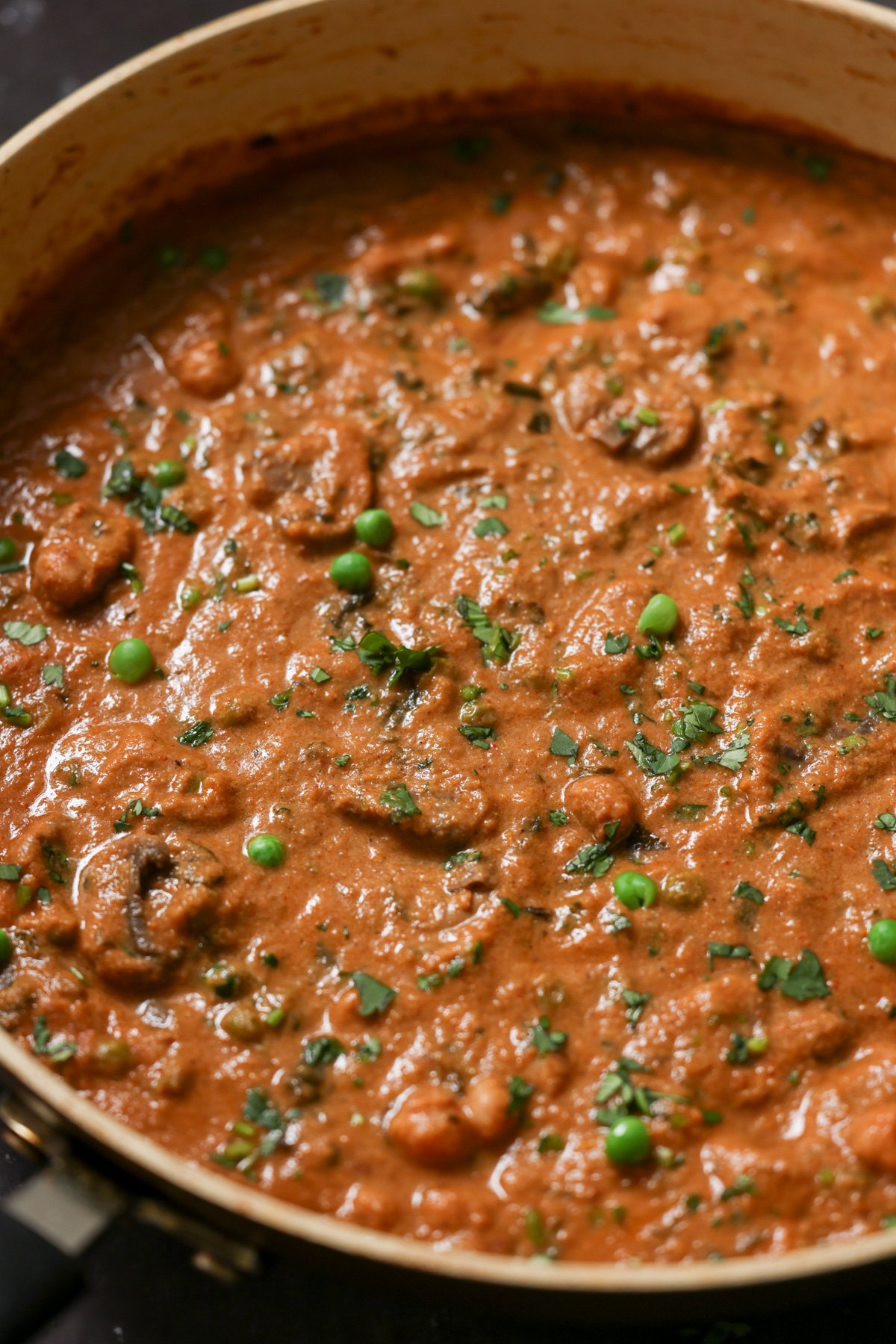 close-up of mushroom matar masala in the pan after cooking and adding garnish