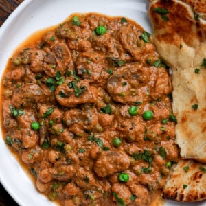 bowl of mushroom matar masala with flatbread