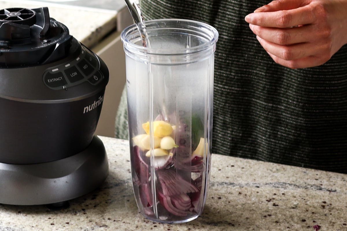 adding water and aromatics to the blender