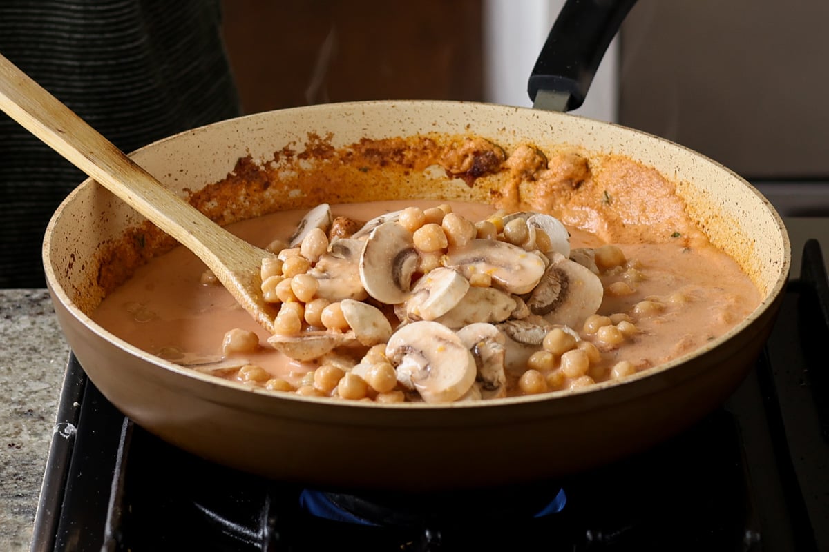 adding chickpeas to the pan