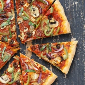 Easy Veggie Vegan Pizza with 20 minute Almost No Knead Crust! Pizza Sauce, Veggies, Mushrooms, Kalamata Olives baked to perfection. Dressed with Vegan Parmesan and fresh basil. Vegan Soy-free Recipe. Can be Nut-free | VeganRicha.com #glutenfree #veganricha #vegan