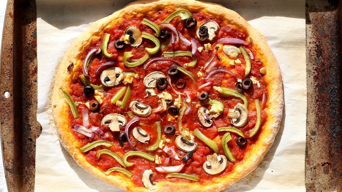 Easy Veggie Vegan Pizza with 20 minute Almost No Knead Crust! Pizza Sauce, Veggies, Mushrooms, Kalamata Olives baked to perfection. Dressed with Vegan Parmesan and fresh basil. Vegan Soy-free Recipe. Can be Nut-free | VeganRicha.com