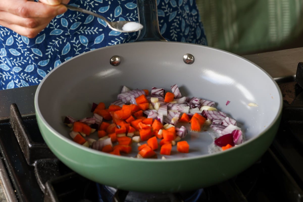 adding veggies to the pan