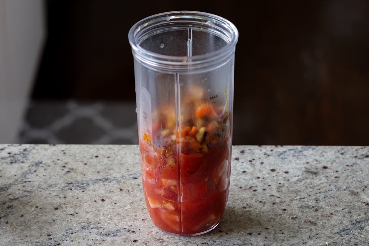 tomatoes and cooked veggies in the food processor