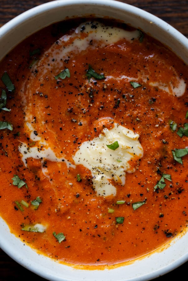 bowl of spiced tomato soup with garnishes