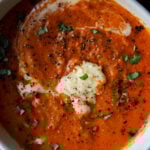 close-up of bowl of spiced tomato soup with garnishes