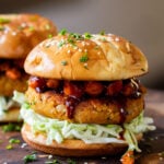 Peanut white bean burger topped with roasted sweet potato, cabbage and burger buns