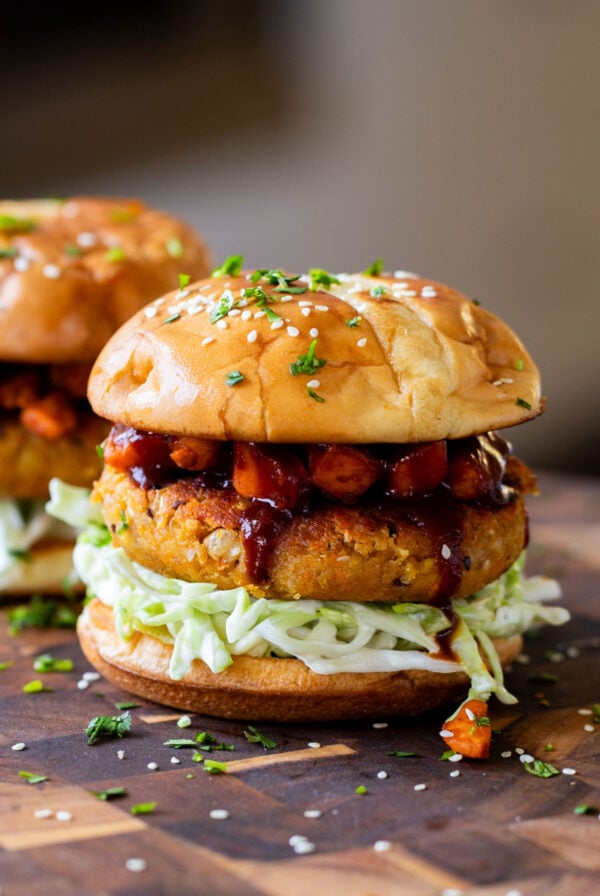 Peanut white bean burger topped with roasted sweet potato, cabbage and burger buns