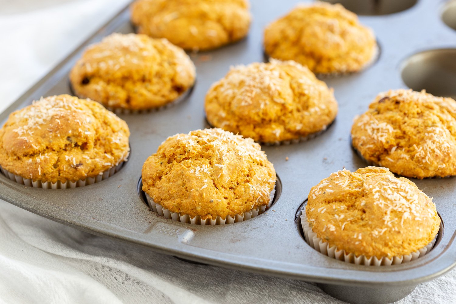Our Vegan Turmeric Carrot Muffins in a muffin pan