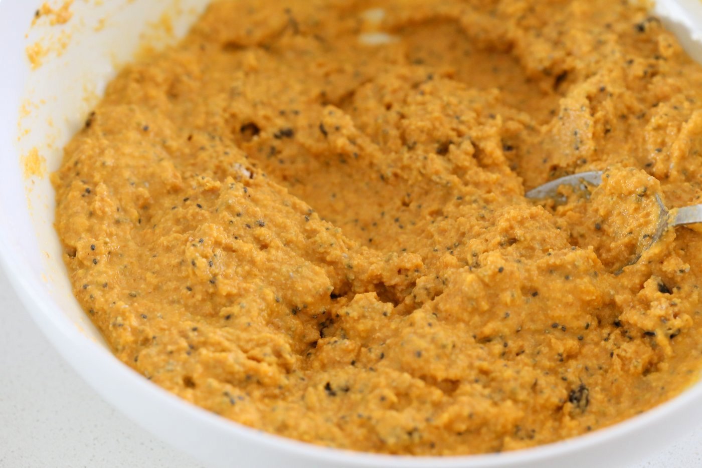 Our Vegan Turmeric Carrot Muffins batter in a white plate