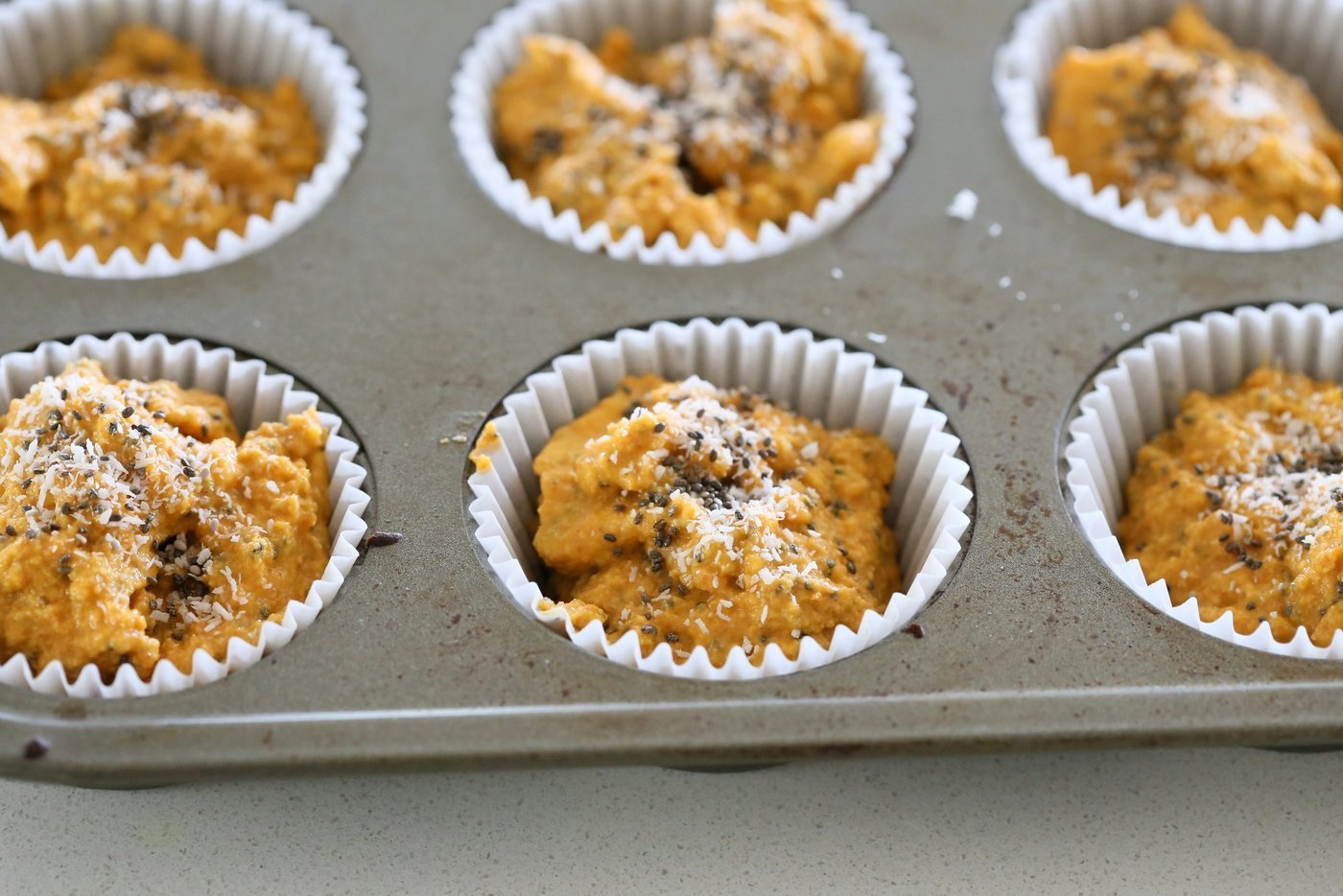 Our Vegan Turmeric Carrot Muffins in a muffin pan