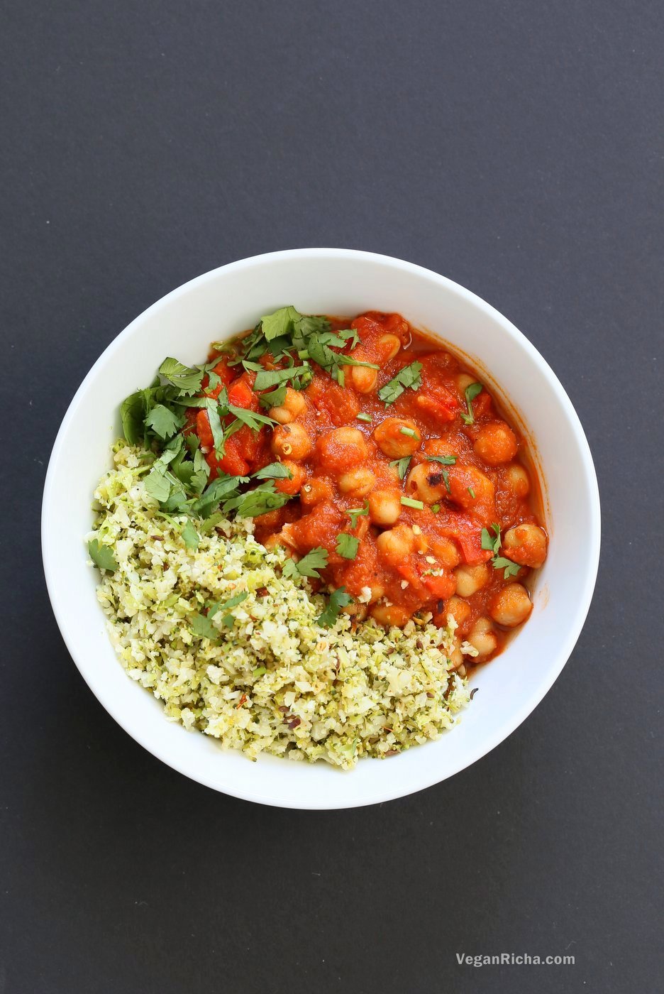Flavorful Spanish Chickpea Stew with Cumin scented Cauliflower Broccoli Rice. Smoky tomatoey Chickpea Stew can be served over rice or grains or cauliflower or broccoli rice. Vegan Gluten-free Nut-free Grain-free Soy-free Recipe | VeganRicha.com