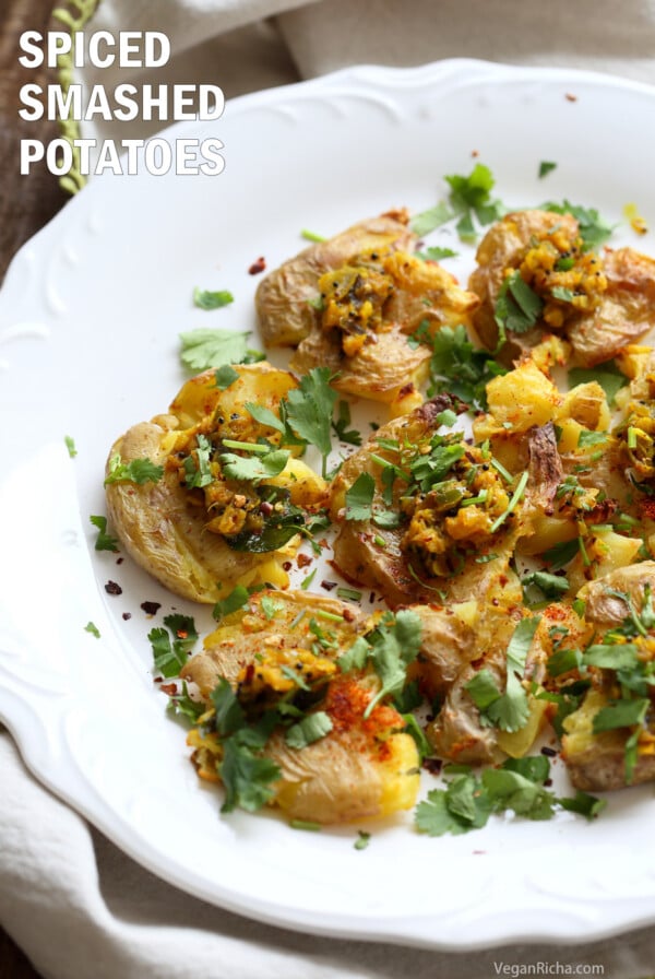Indian Spiced Smashed Potatoes with Mustard Ginger Tempering. Bonda like Samosa is a spiced potato snack. These smashed potatoes are topped with Bonda style tempering of ginger, chile, turmeric and mustard seeds. Vegan Gluten-free Recipe | VeganRicha.com
