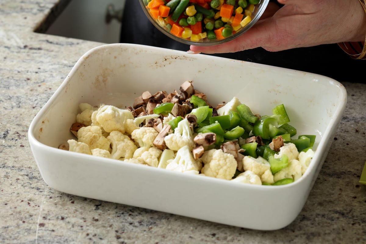adding frozen veggies to the casserole dish