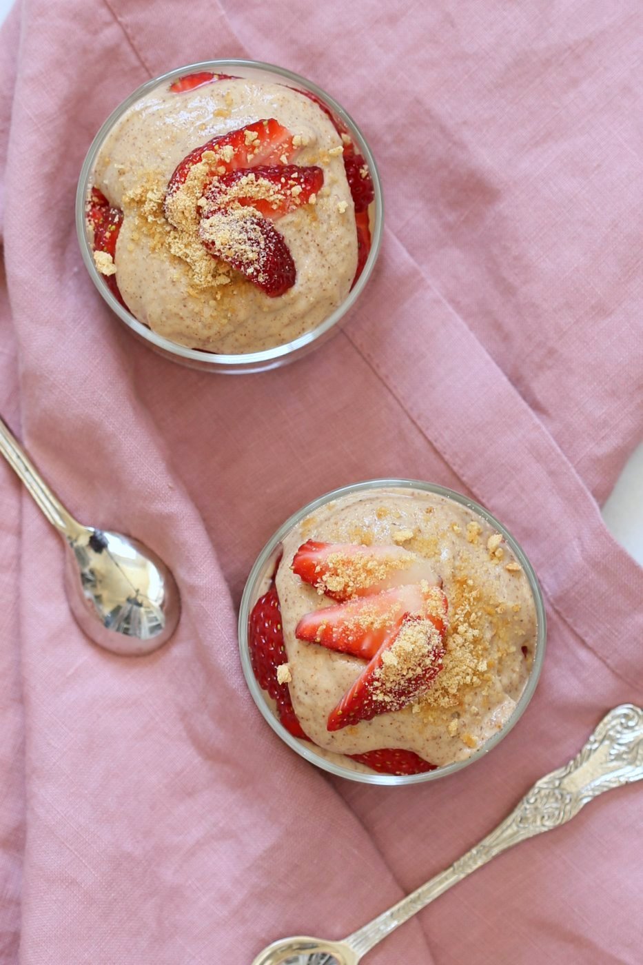 Almond Butter Mousse Strawberry Parfaits in glass containers over pink napkin