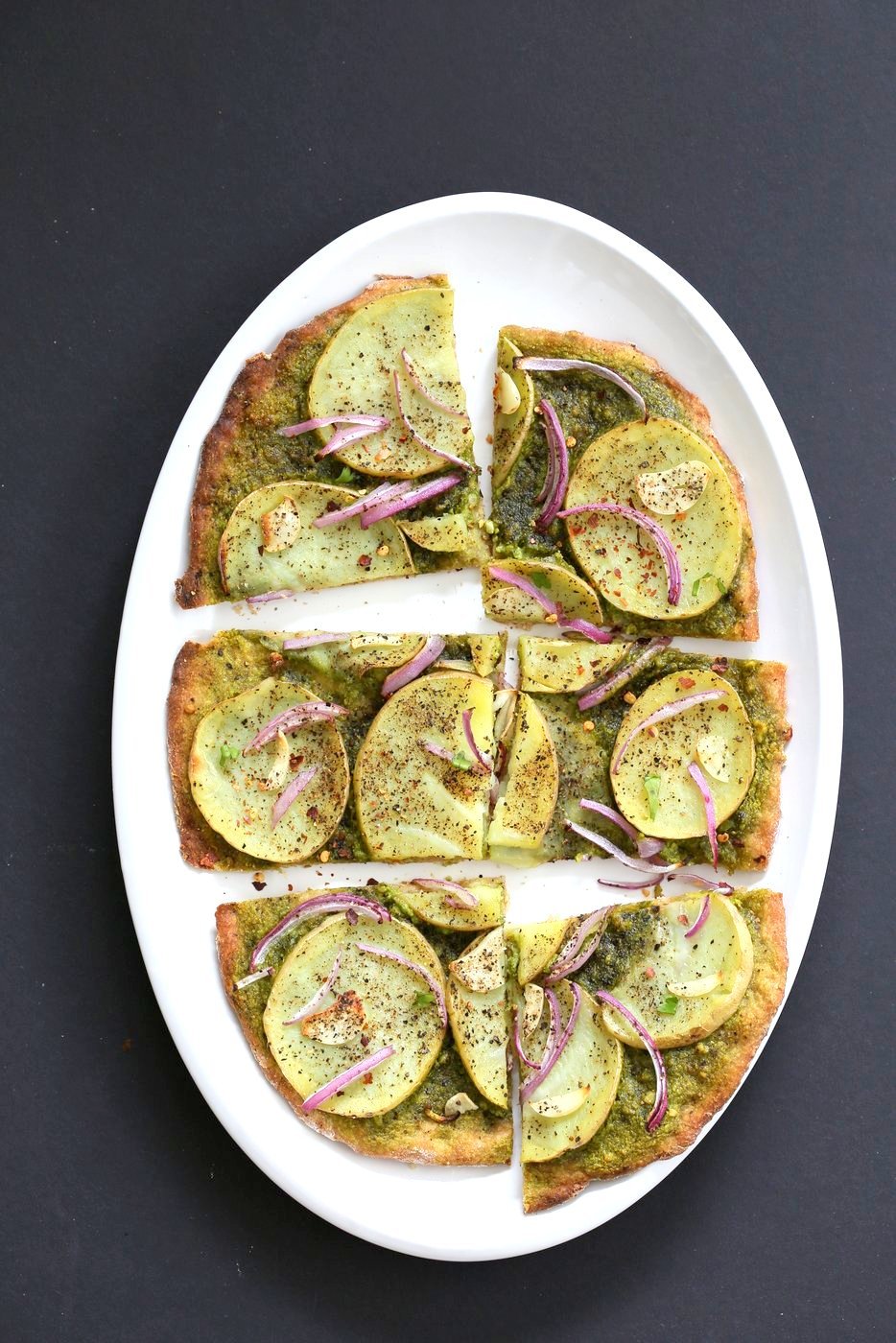 Easy Potato Pesto Pizza with Thin Crust. Basil Spinach Pesto makes for a refreshing Pizza base topping with thin potato slices, onion and garlic. Bake or make on the grill. Vegan Soyfree Recipe. | VeganRicha.com