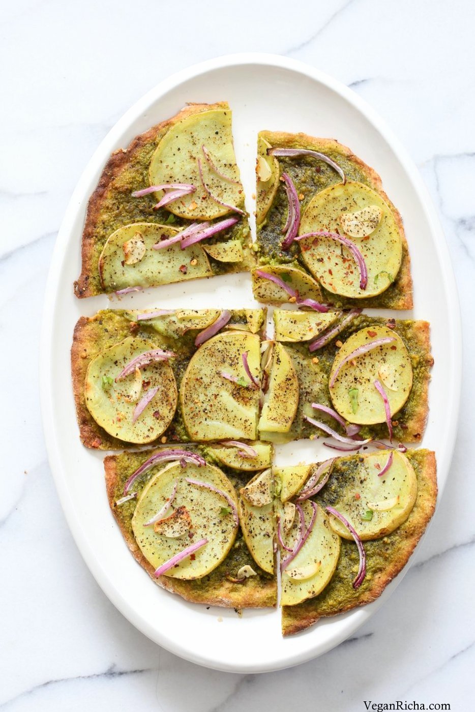 Easy Potato Pesto Pizza with Thin Crust. Basil Spinach Pesto makes for a refreshing Pizza base topping with thin potato slices, onion and garlic. Bake or make on the grill. Vegan Pesto Pizza Soyfree Recipe. | VeganRicha.com